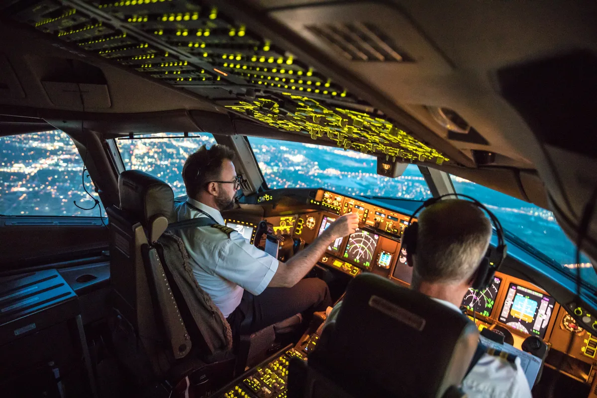 Airline pilot at the controls in a commercial jet cockpit