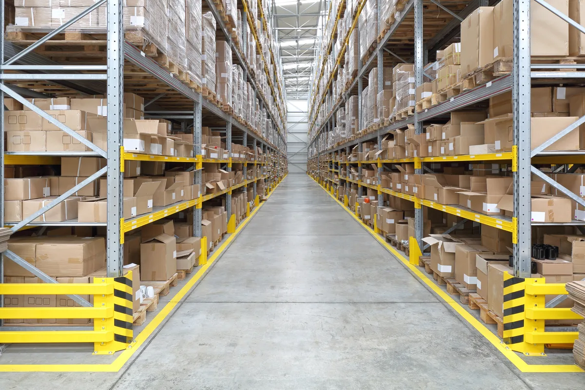 Workers moving stock through an Amazon FBA fulfilment warehouse