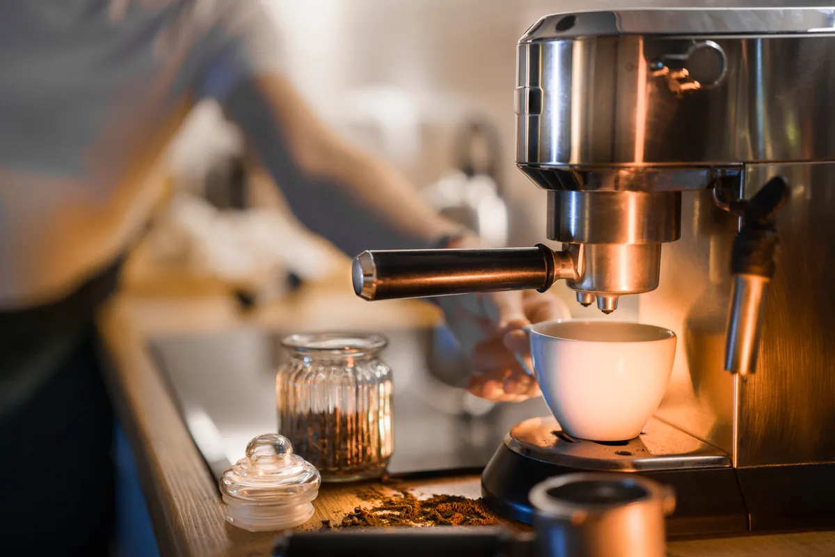 Barista preparing espresso drinks at the counter of an independent cafe