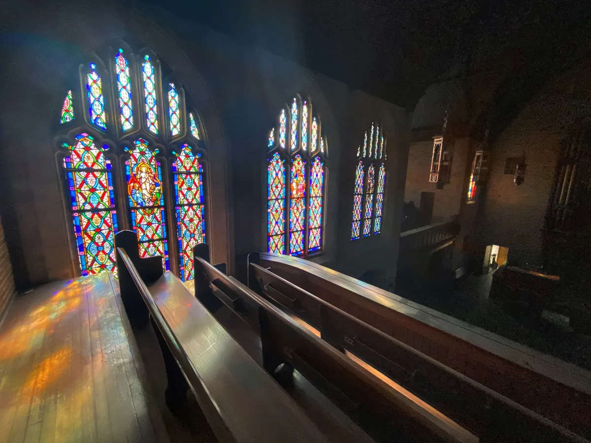 Interior of a church sanctuary with rows of wooden pews