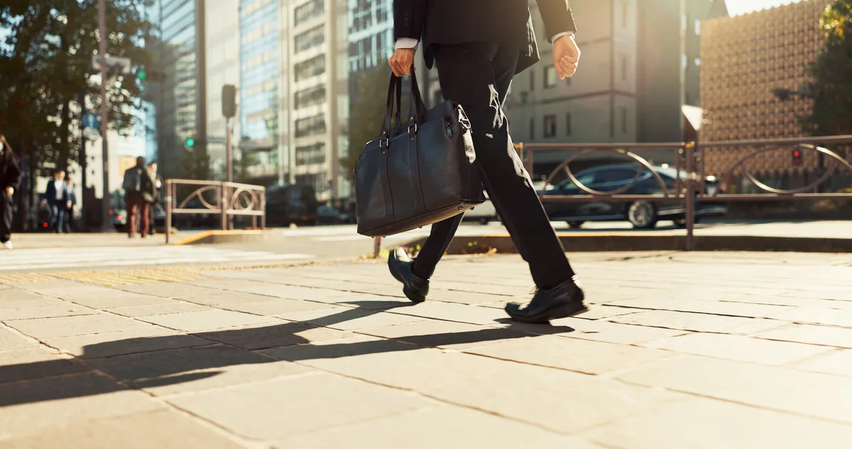 Commuter arriving at a US office building with a laptop bag