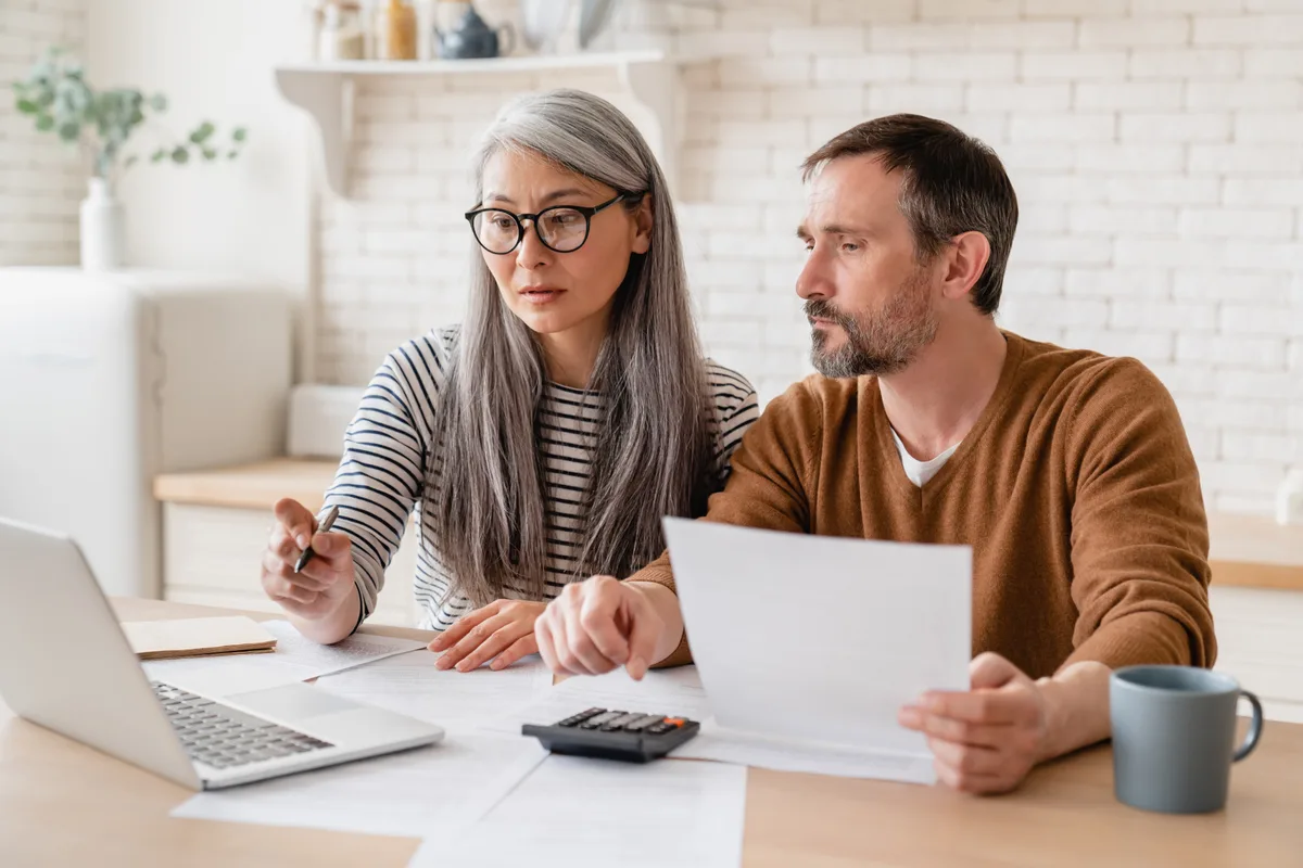 Immigration consultant reviewing application documents with a couple