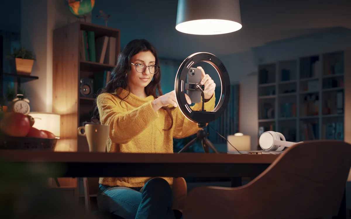 Content creator filming a video with a camera and ring light