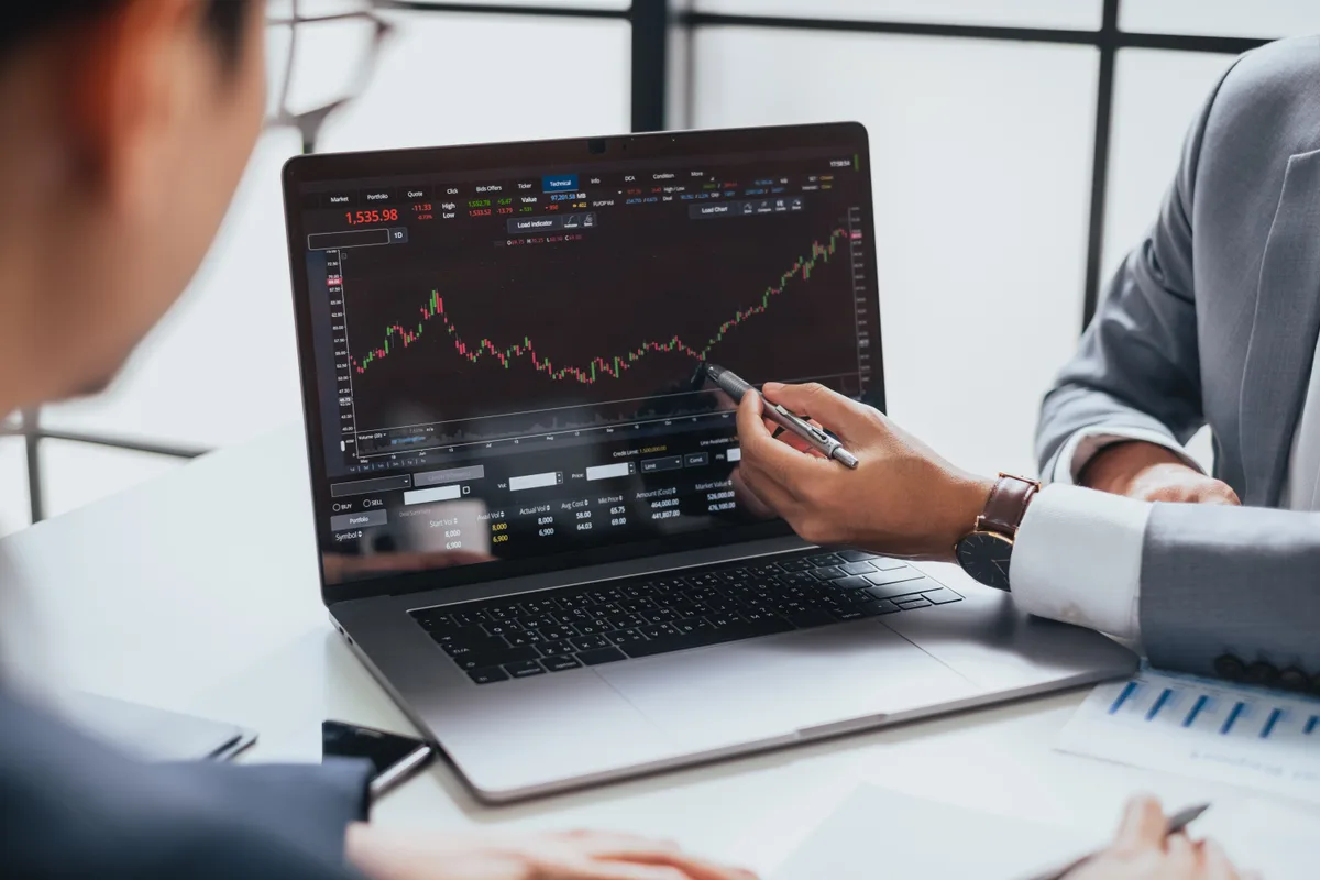 Crypto investor reviewing exchange charts on a laptop