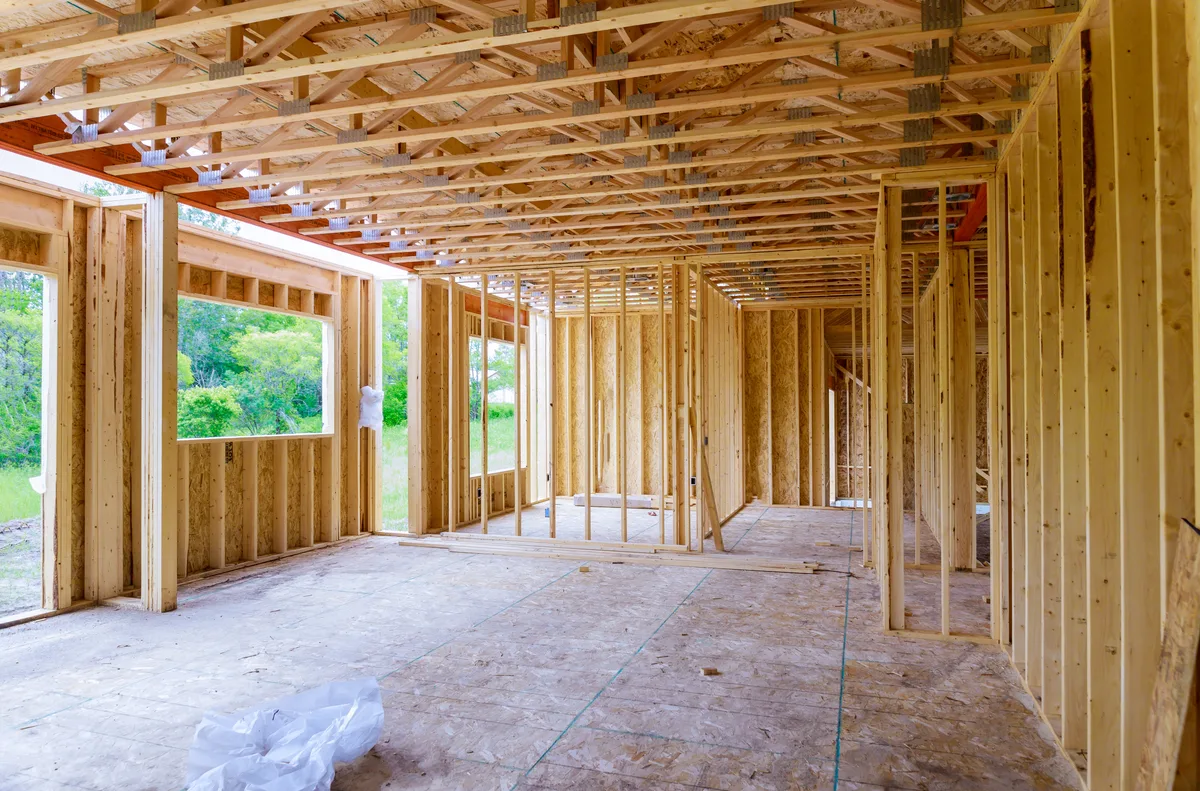 Framing stage of a custom home showing the structural skeleton