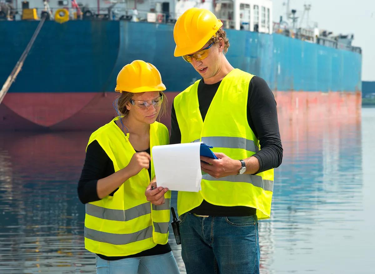 Customs broker reviewing entry files with a manager