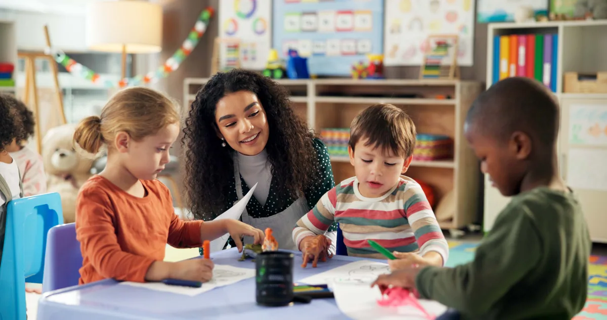 Early childhood educator working with children in a daycare classroom