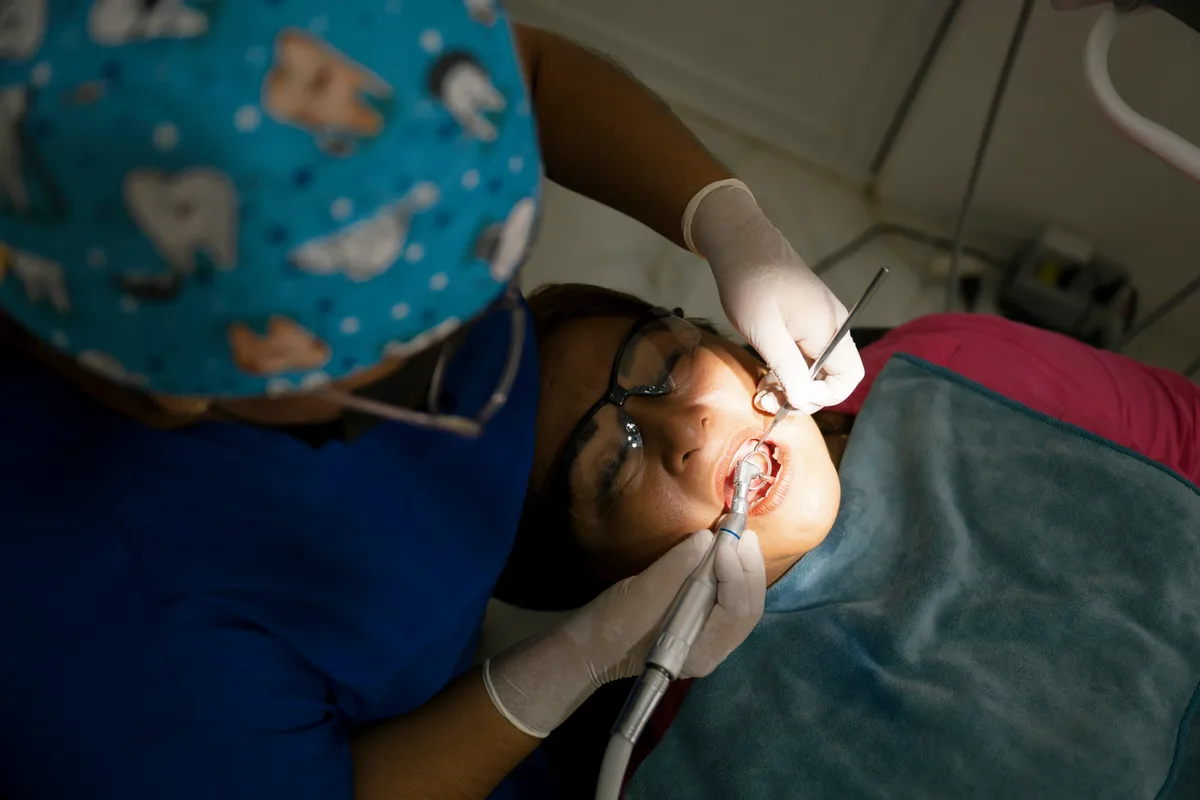Dental hygienist performing a cleaning on a patient