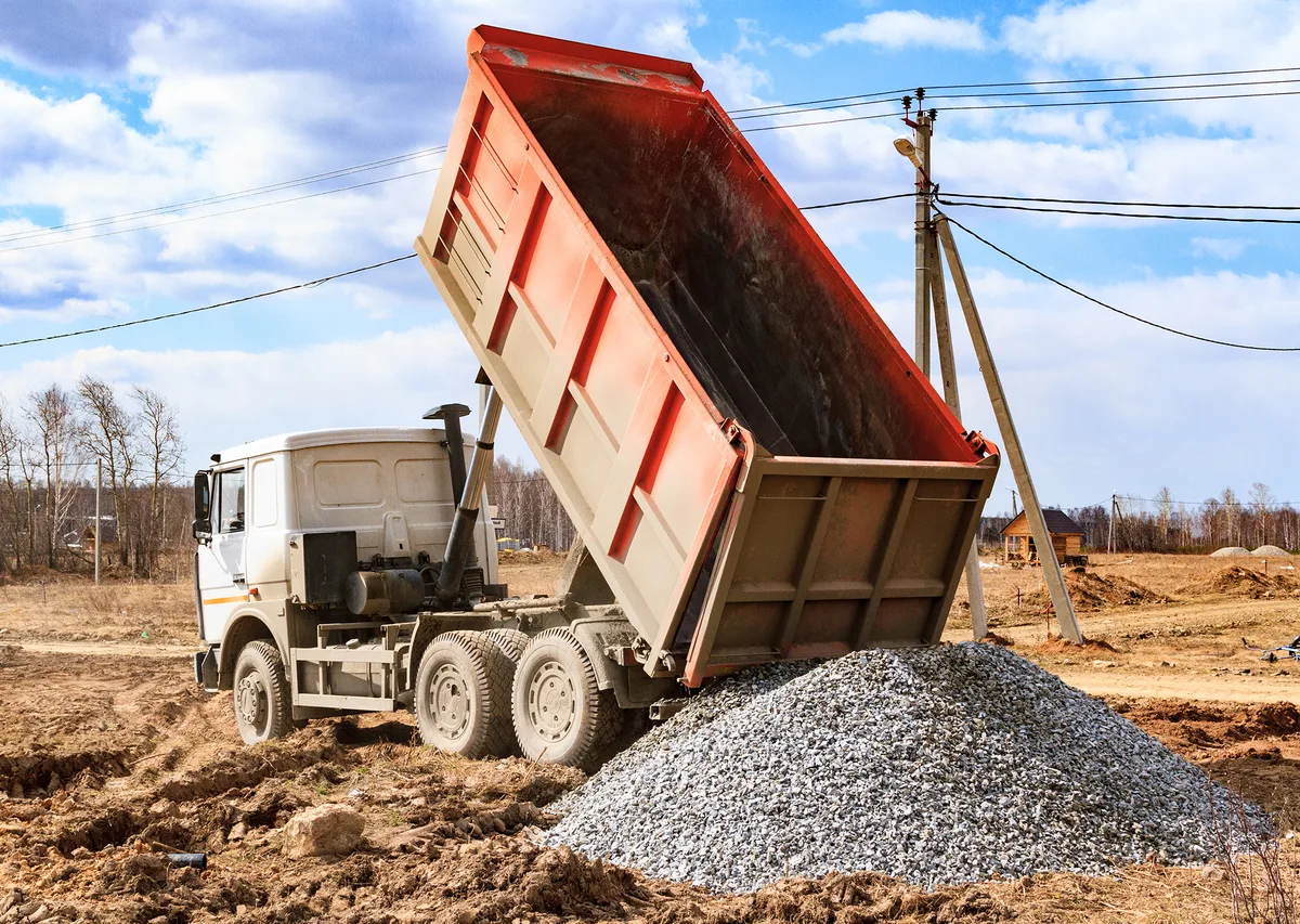 Dump truck being loaded with gravel at an aggregate yard