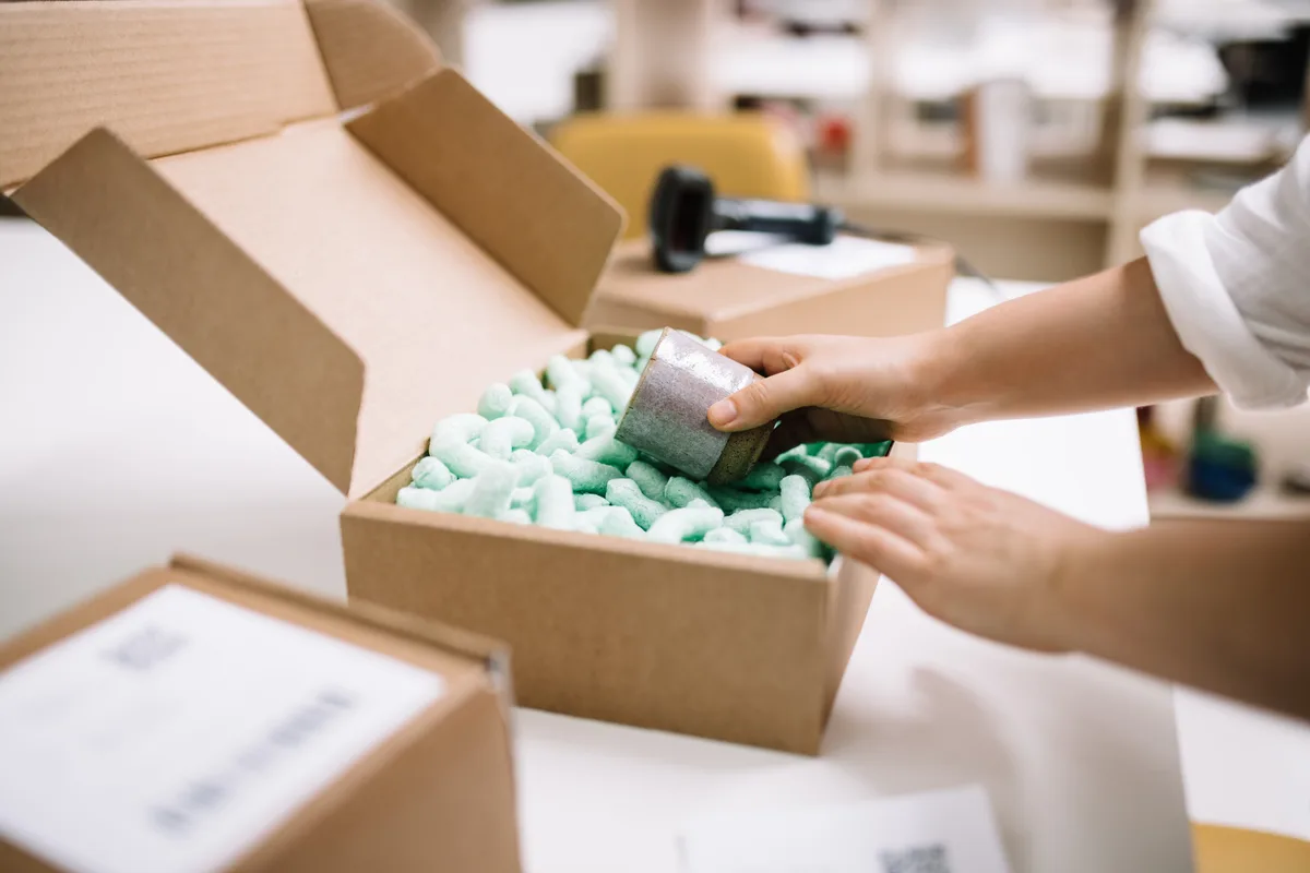 E-commerce seller packing customer orders for shipment to the US