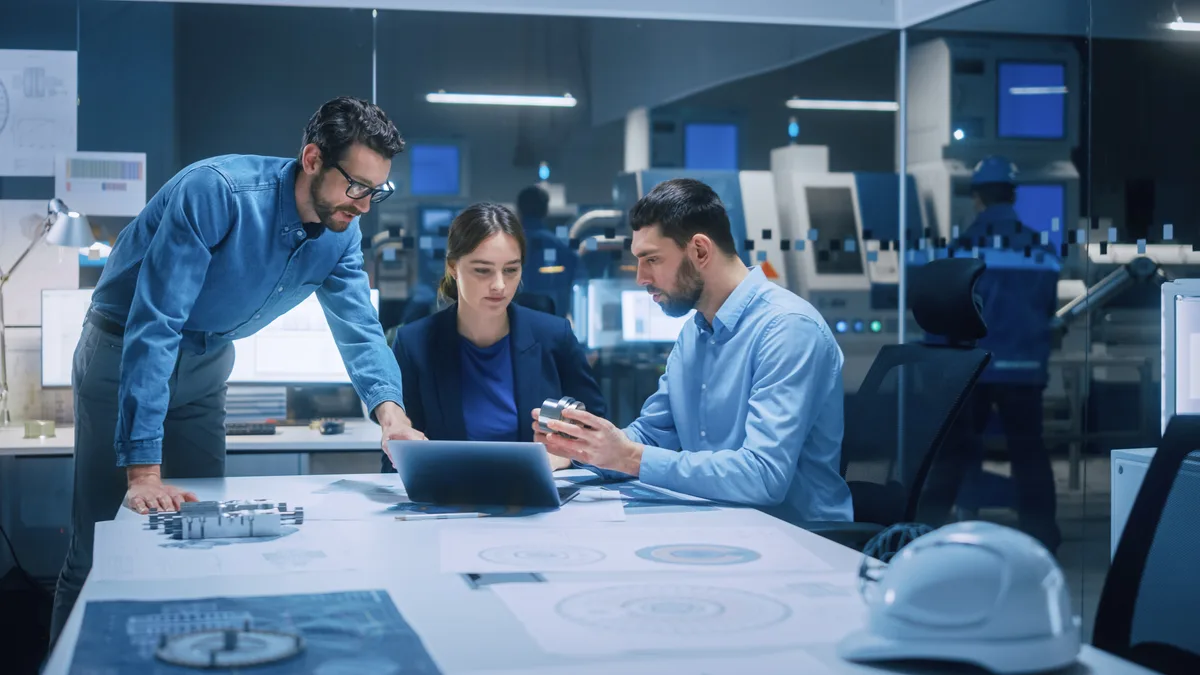 Two engineers reviewing a set of construction plans together