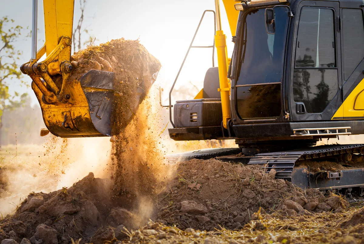 Hydraulic excavator digging a trench on a construction site