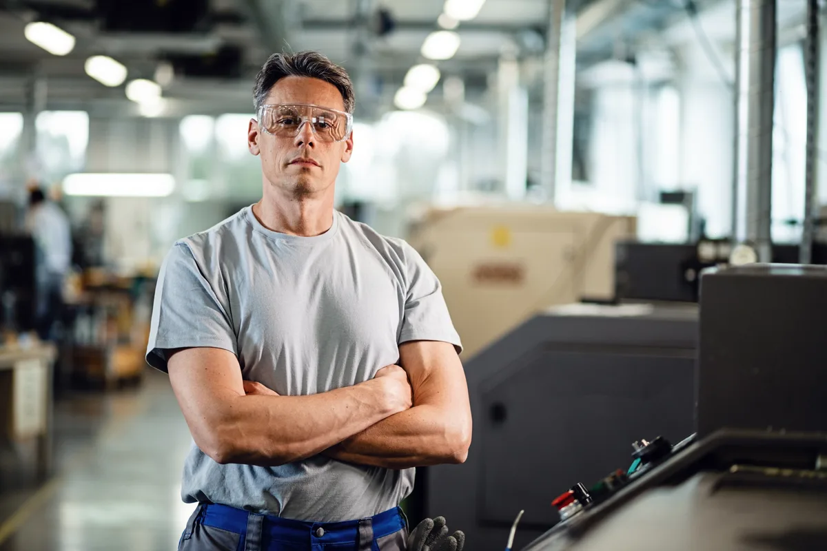 CNC machine cutting a metal part on a manufacturing floor