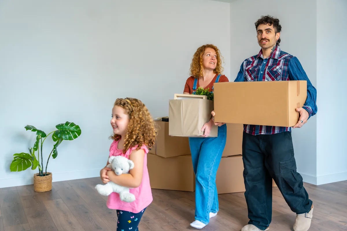 Family unpacking moving boxes in a new Canadian home