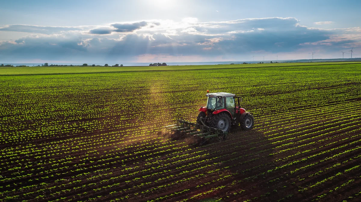 Farmer working a field with a tractor on an Ontario farm