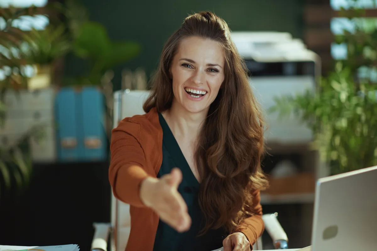 Small business owner onboarding a new employee at a shared desk in an Ontario office