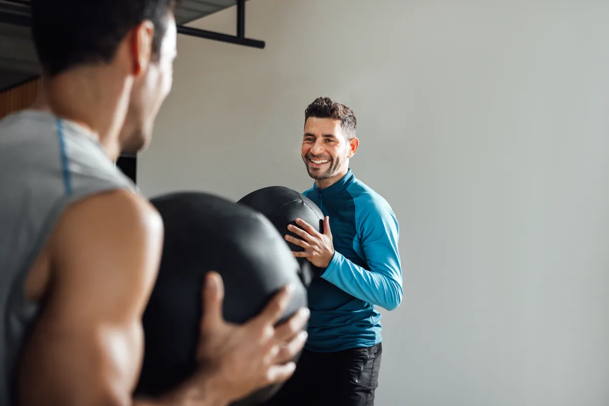 Fitness instructor leading a group class at a studio