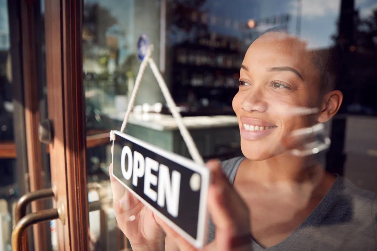 Franchise owner standing at the front of their branded storefront