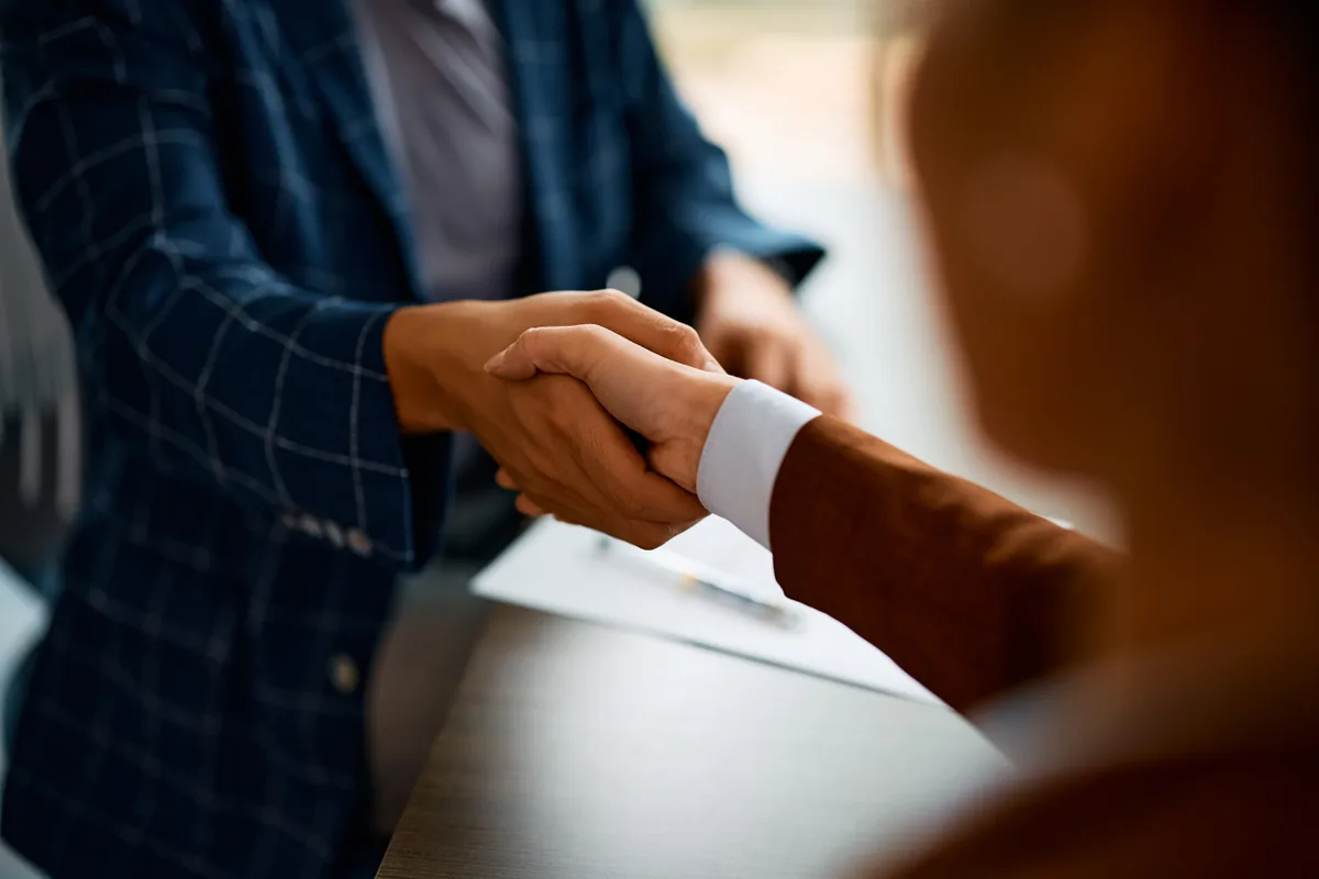 Insurance broker working with policy files in a brokerage office