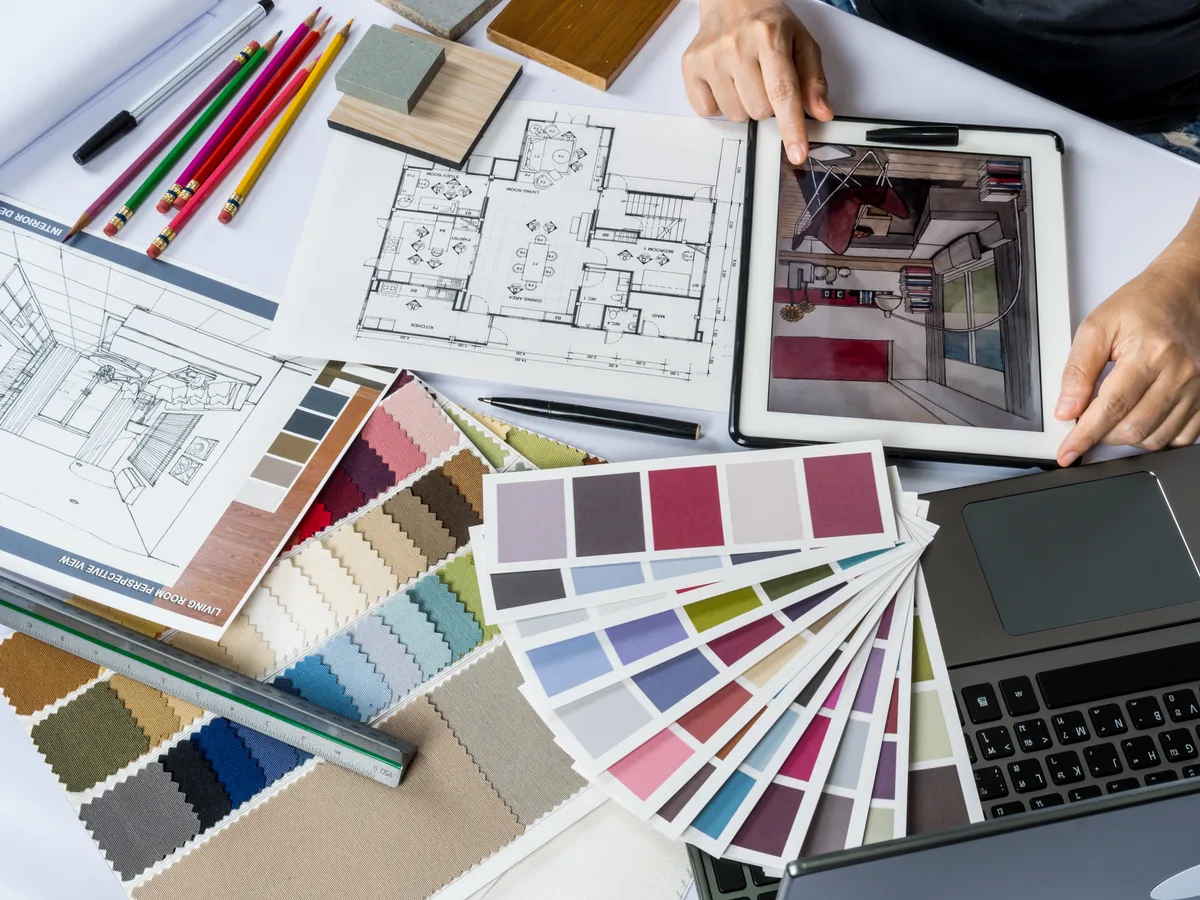 Interior design studio with a designer comparing finish and fabric options for a project