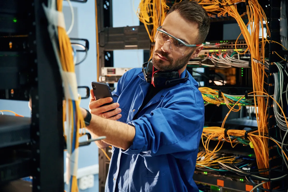 IT technician monitoring servers in a data room
