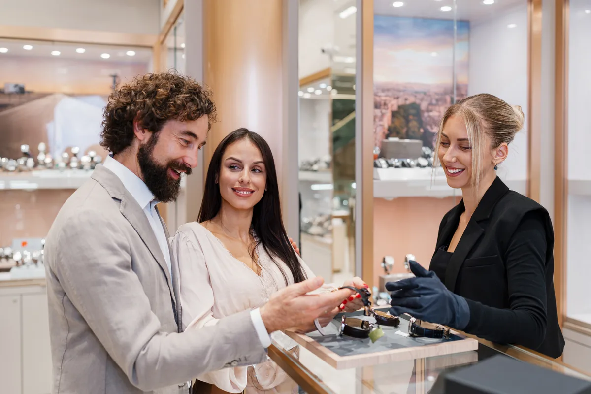 Jeweller and sales associate reviewing a repair ticket at the counter