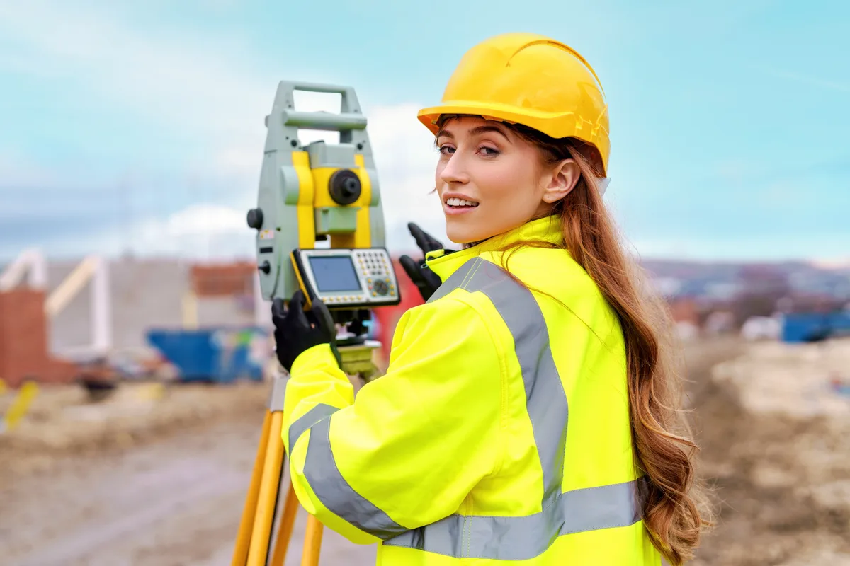 Survey firm owner reviewing project numbers at a desk