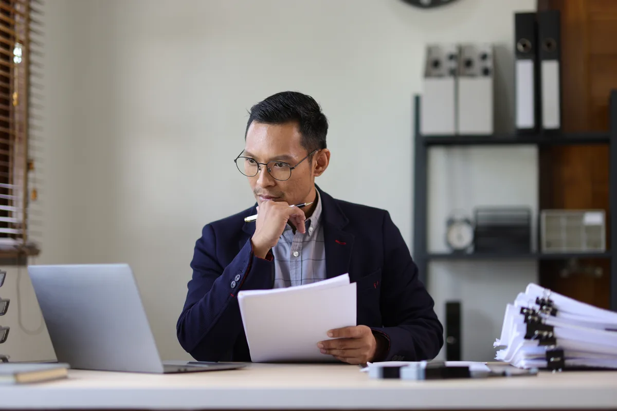 Lawyer reviewing files and paperwork in a law office