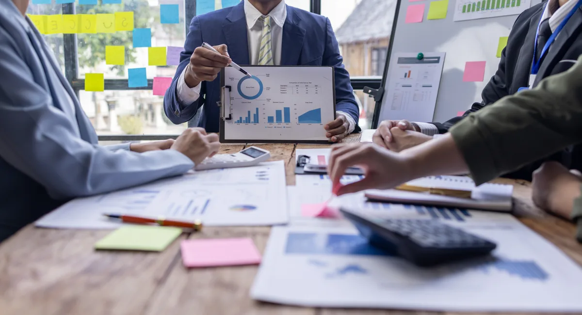 Management consultant and business owner reviewing a financial dashboard