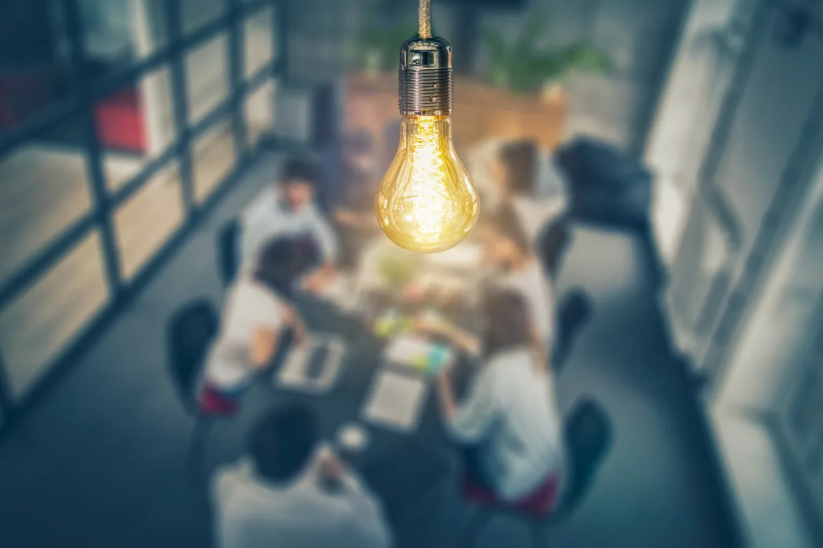 Marketing agency team collaborating around a table in a studio office