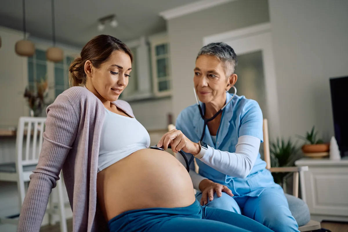 Midwife checking in with a client during a prenatal visit