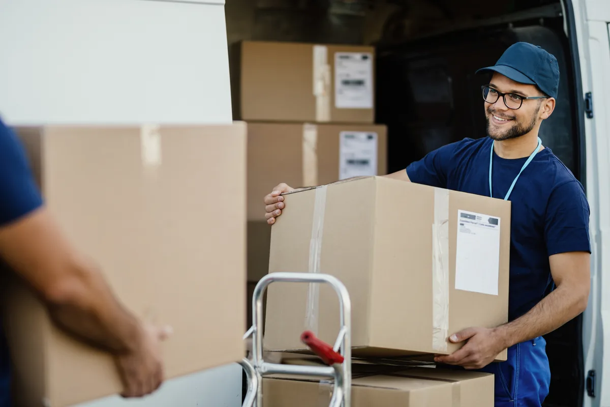 Moving crew loading boxes into the back of a truck