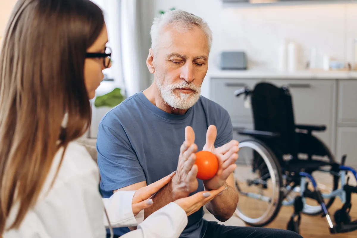 Occupational therapist helping a patient with a rehabilitation exercise