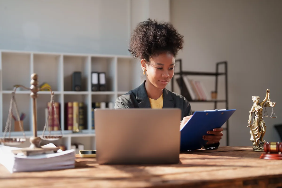Paralegal reviewing legal documents at a desk