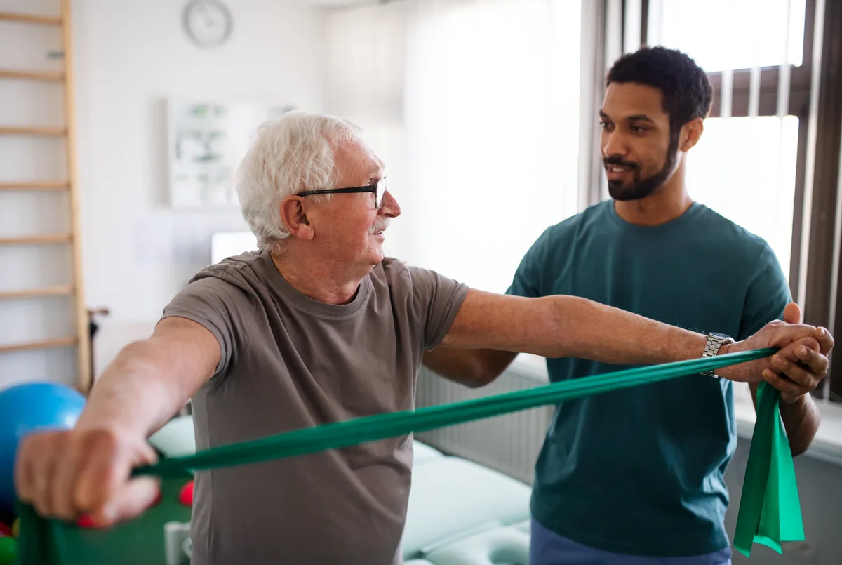 Physiotherapist guiding a patient through rehabilitation exercises