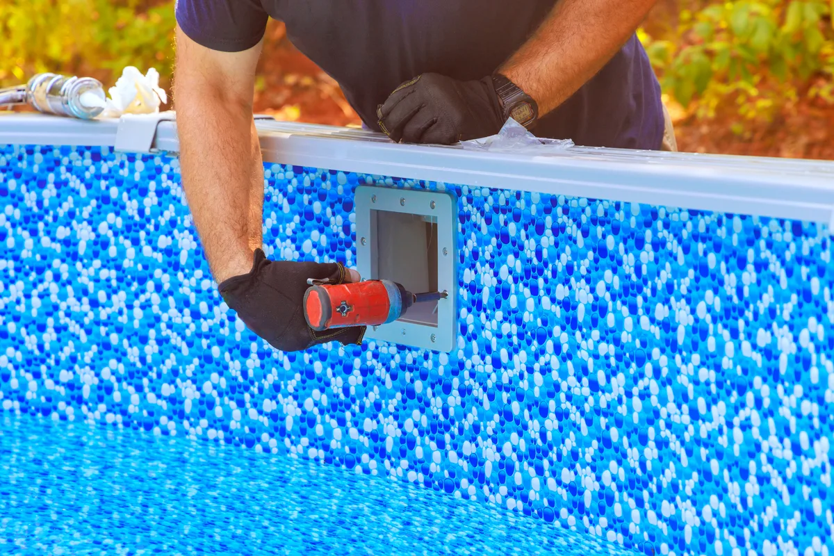 Crew constructing an inground swimming pool in a residential backyard