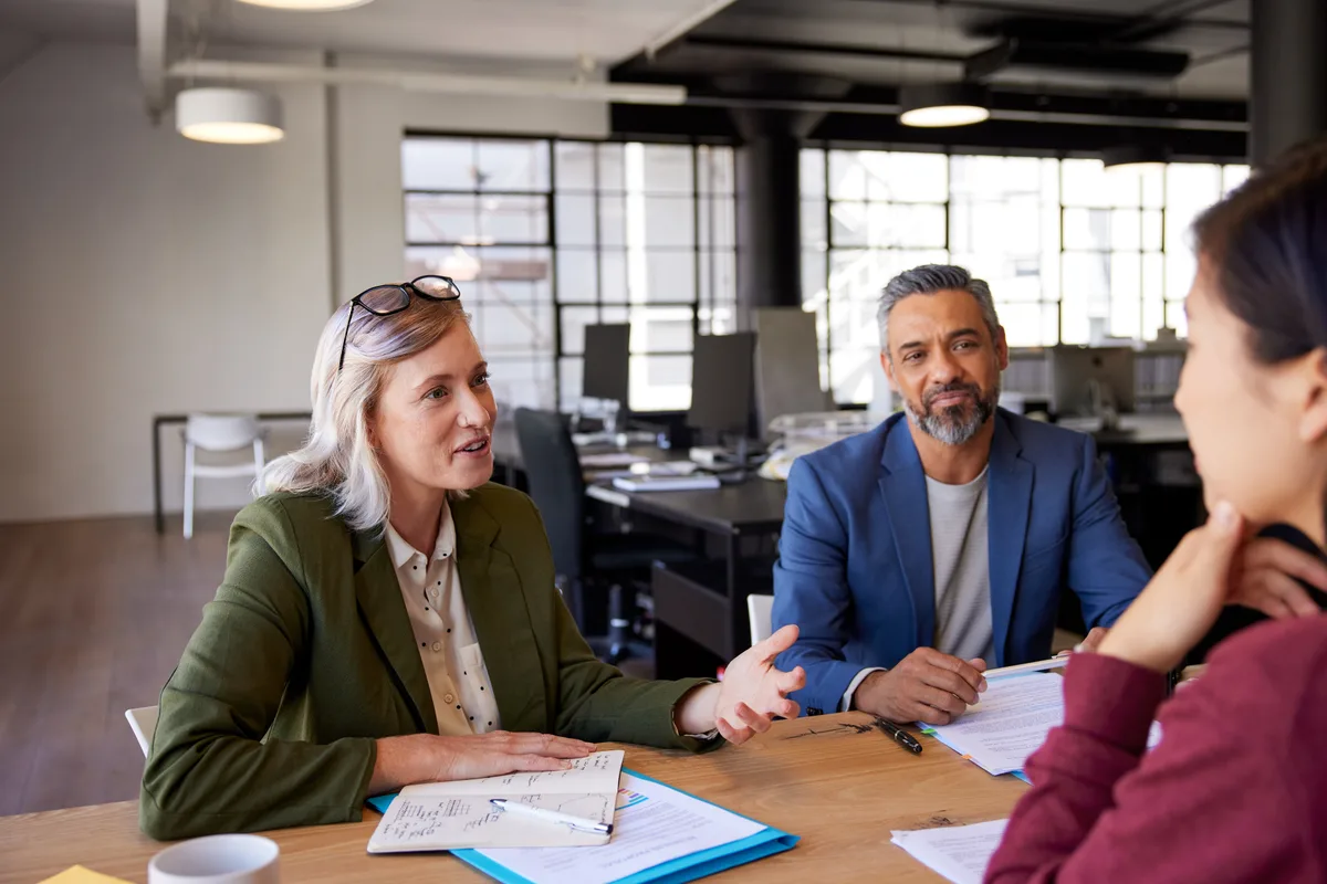 Recruiter interviewing a candidate across an office desk