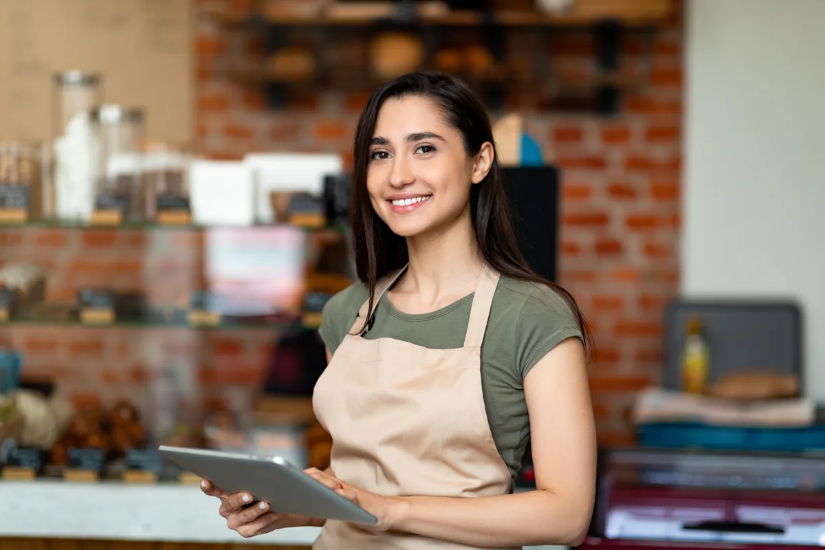 Restaurant owner at the counter with a tablet