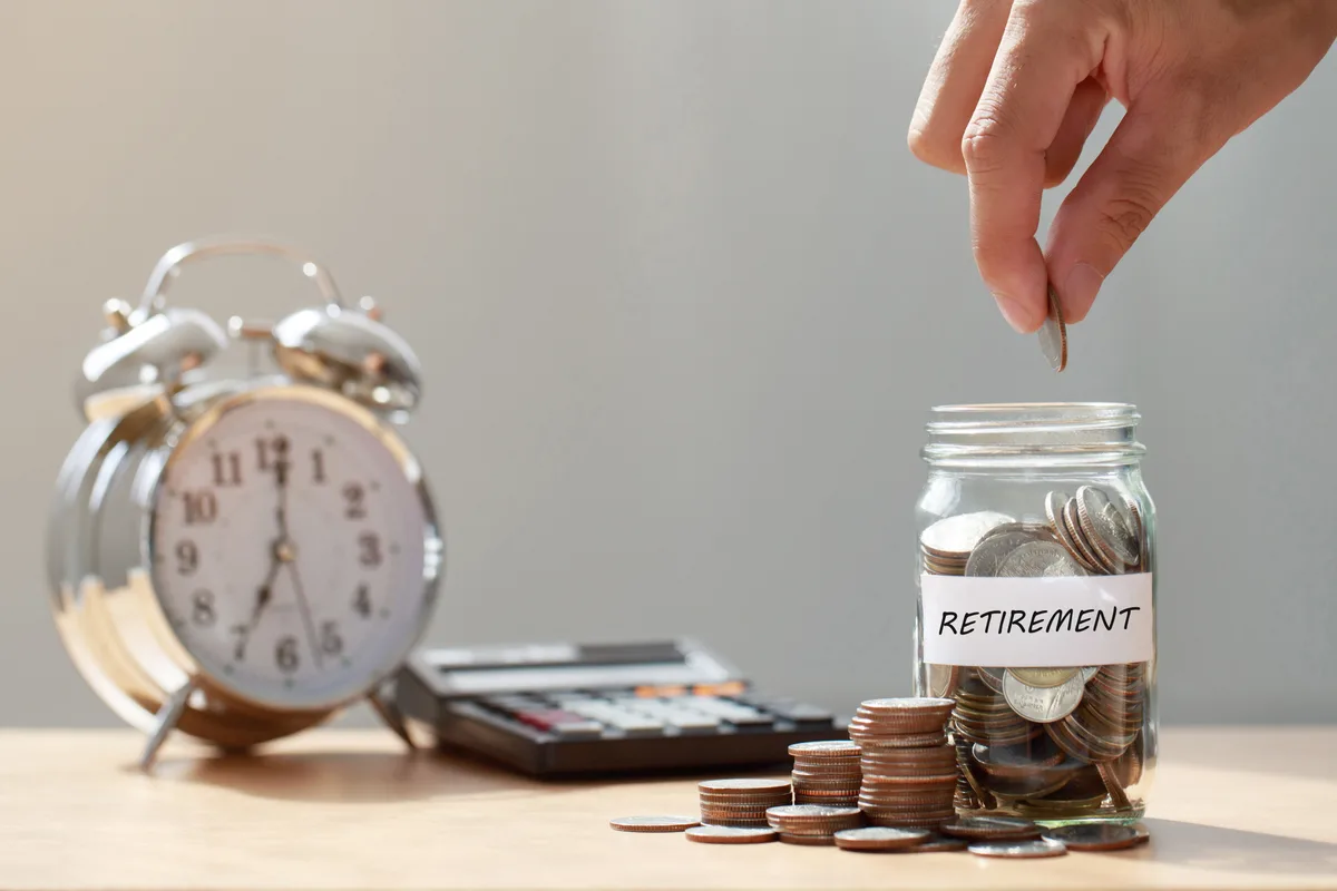 Retirement savings jar beside cross-border account statements