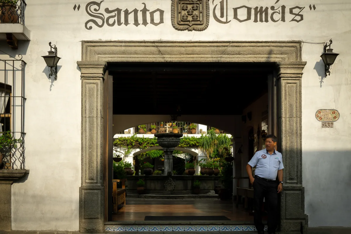 Uniformed security guard on duty at a commercial building lobby