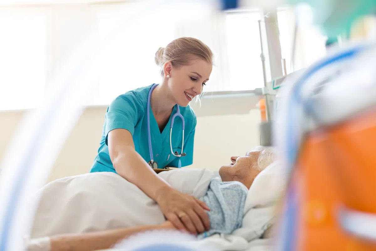 Caregiver walking with a resident through a retirement residence