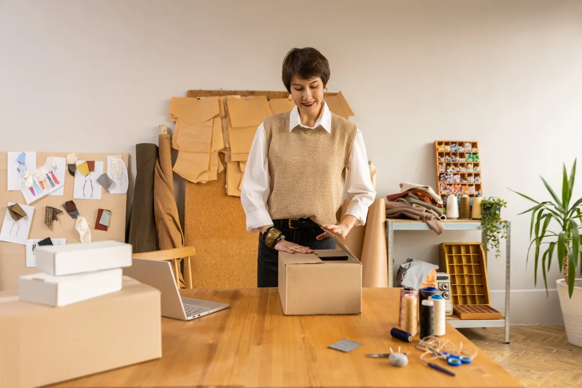 Shopify brand owner reviewing orders and team schedules in a studio workspace
