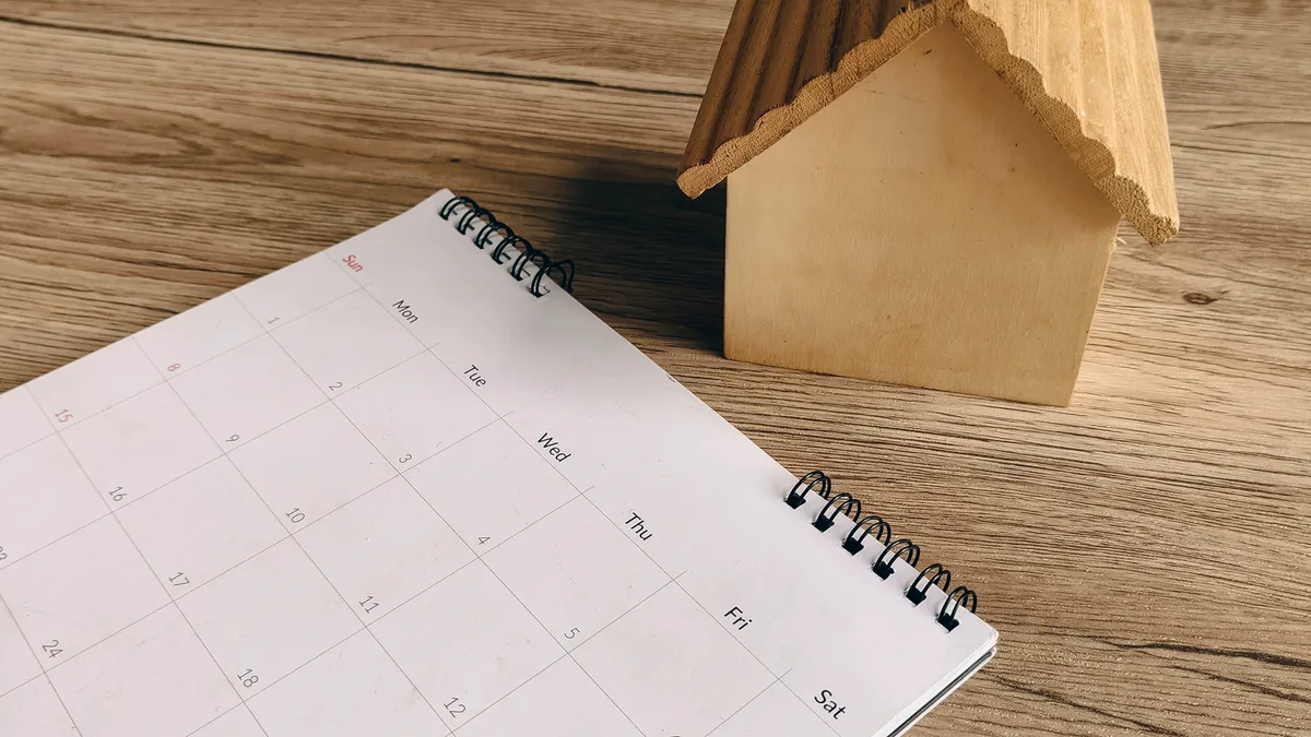 Wall calendar with Canadian tax deadlines circled beside a laptop and CRA notices