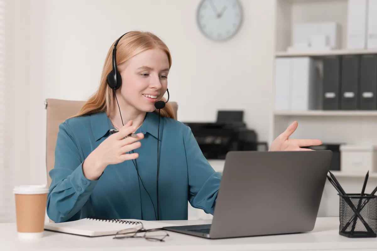 Translator wearing a headset working at a laptop
