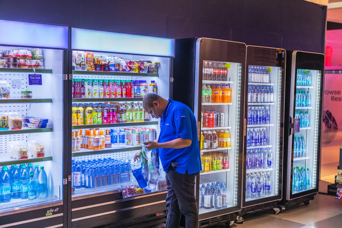 Operator restocking a vending machine on a service route