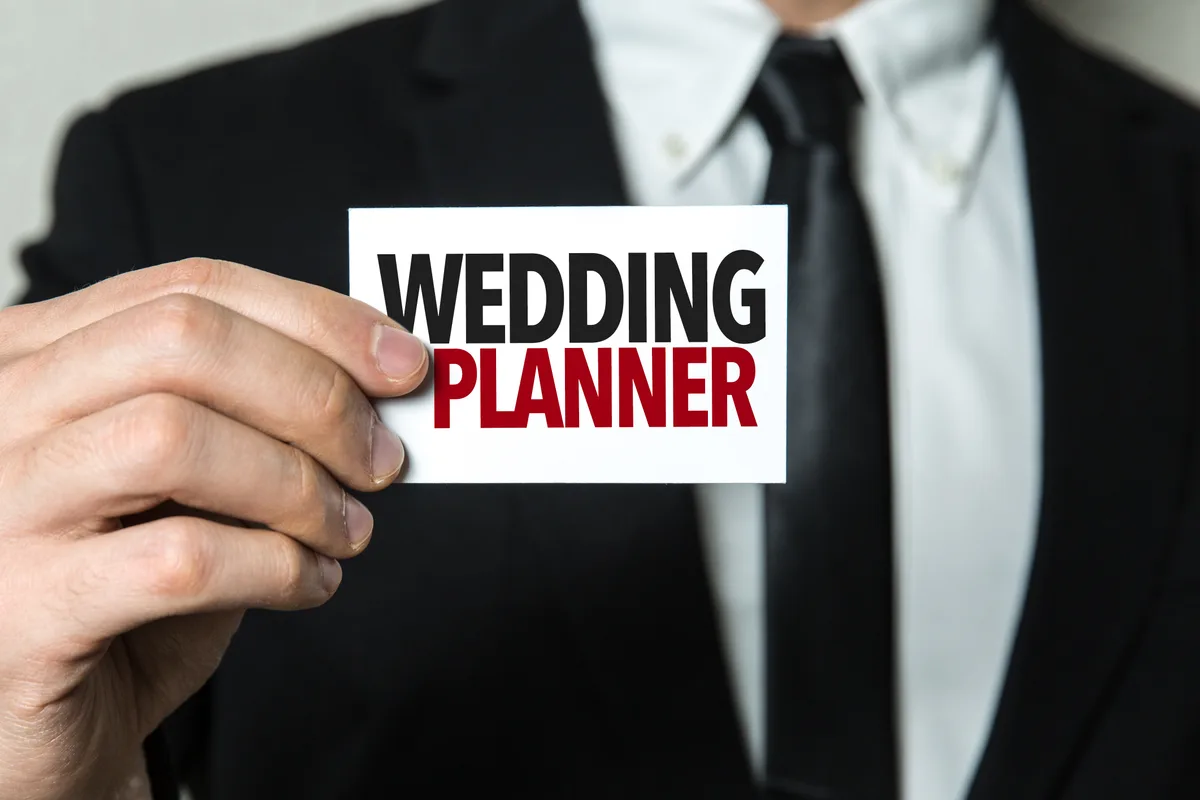 Wedding planner reviewing details in a decorated venue